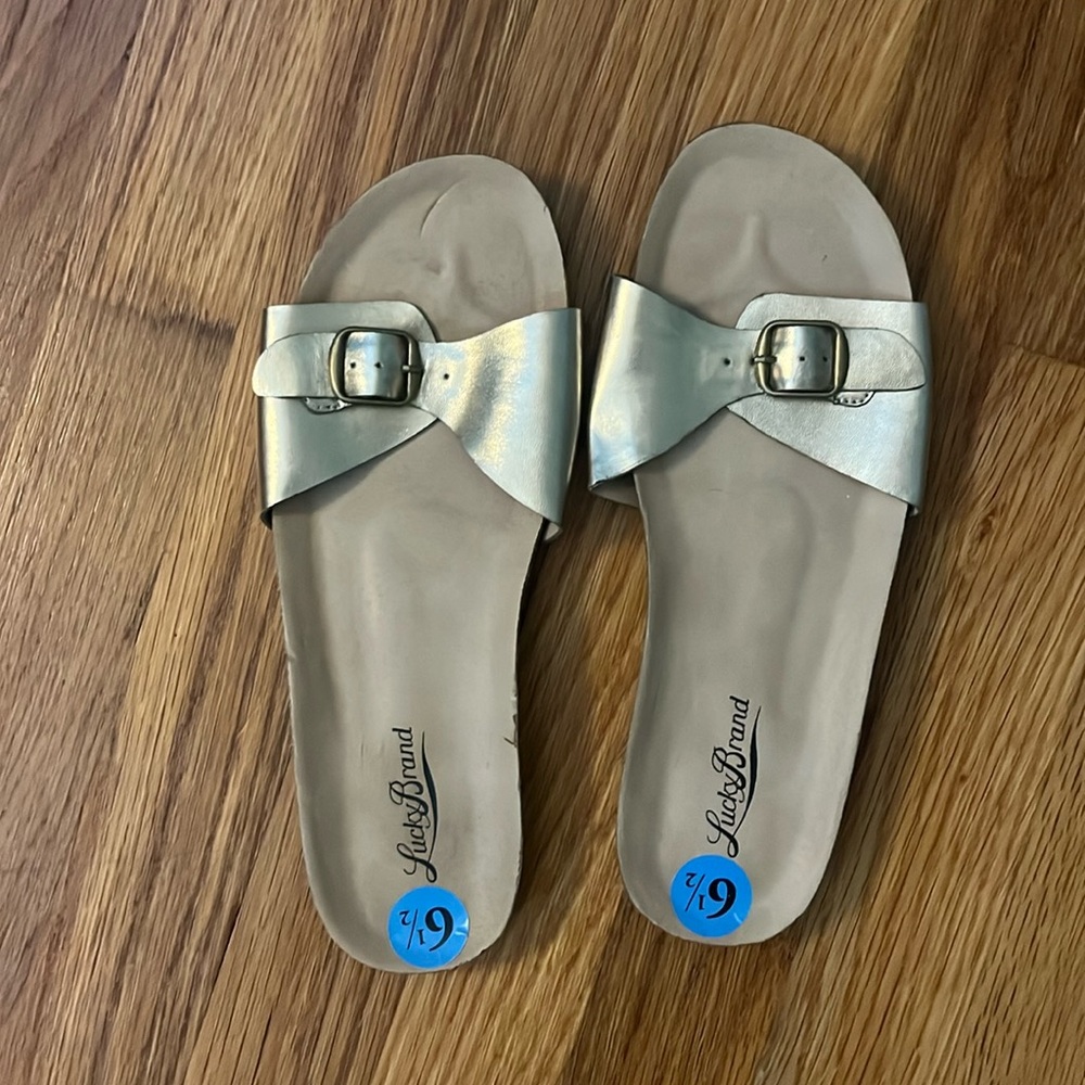NWOT gold lucky slip on sandals